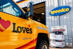 Love's service truck parked in front of a Speedco facility