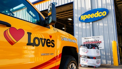 Love's service truck parked in front of a Speedco facility