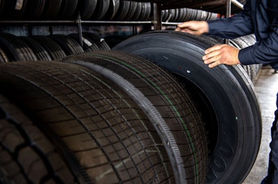 Technician selecting a tire from a tire rack at Travel Centers of America
