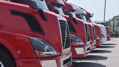 Group of Volvo used trucks parked on a truck lot