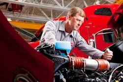 Paccar technician working on engine