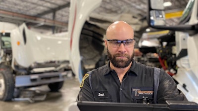 Shop Foreman in a service warehouse at a computer