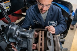 Bendix technician inspecting wheel-end components.