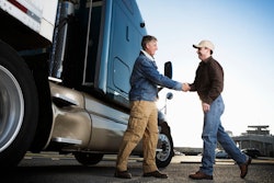 Customer shaking hands with sales person.