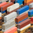 Photo of containers stacked two high in a busy railyard