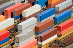 Photo of containers stacked two high in a busy railyard