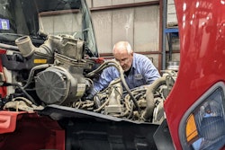 H.K. Truck Center technician working on a truck engine.