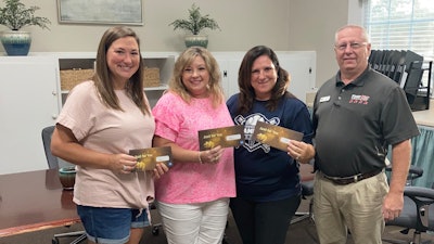 Four Star Freightliner employee Lee Barnard presents Lynn Etheredge, Mary Beth Morris and Michelle Brooks with $250 gift cards. They are all teachers at Baconton Community Charter School in Baconton, Ga.