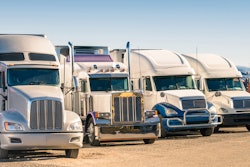 Used trucks parked in lot.