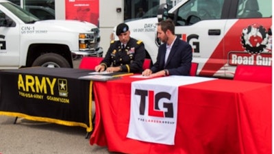 Columbus Recruiting Battalion Commander LTC Brett Gambacorta and Nathan Conn, vice president of human resources, TLG Peterbilt, sign the memorandum of agreement during the signing ceremony in Cincinnati.