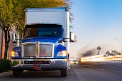 Kenworth truck driving on city street