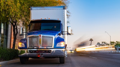 Kenworth truck driving on city street