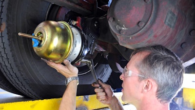 Bendix technician working under truck.