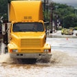 Truck driving through flooded road