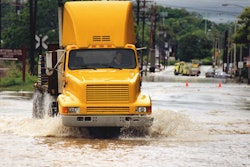 Truck driving through flooded road