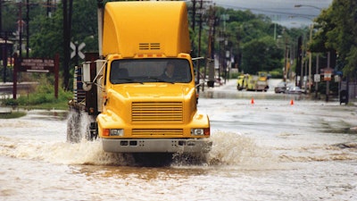 Truck driving through flooded road
