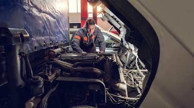 Technician looking at truck