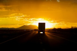 Truck driving into sun