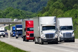 Bunch of trucks in a row on the highway