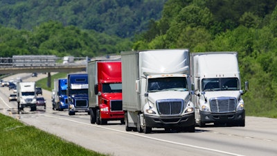 Bunch of trucks in a row on the highway