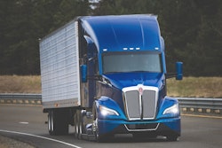 Blue Kenworth tractor on highway