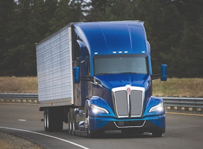 Blue Kenworth tractor on highway