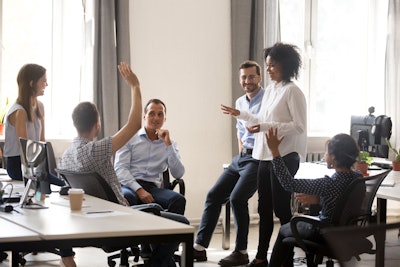 Group of Millennial associates in meeting together