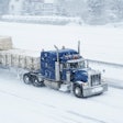 semi truck driving in the snow