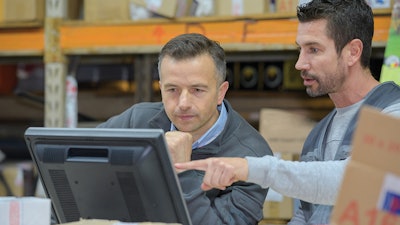 Warehouse employees using a computer