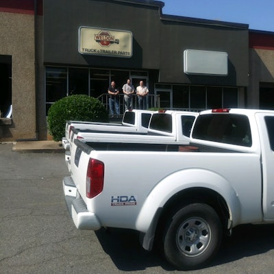 Weldon Parts employees in front of store and trucks