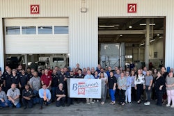 A group of people in front of a garage.