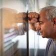 Frustrated man in an office looking at wall