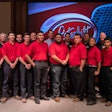 A large group of people in front of a Peterbilt logo.