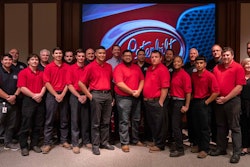 A large group of people in front of a Peterbilt logo.