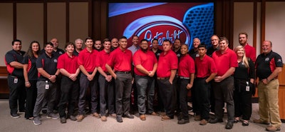 A large group of people in front of a Peterbilt logo.