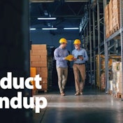Two men walking in a warehouse with the product roundup logo