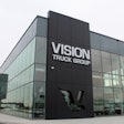 Picture of a glass and metal building with a Vision Truck Group sign.