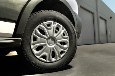 An up-close picture of a tire on a commercial van.