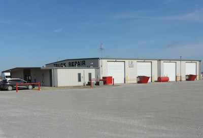 A picture of a truck service center with four service bays.