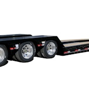 A gooseneck trailer, as seen from behind, with an oversize load sign.