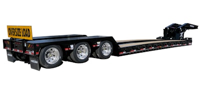 A gooseneck trailer, as seen from behind, with an oversize load sign.