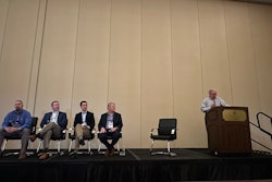 A group of people speaking at a conference.