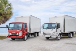 Isuzu van bodies parked by a lake