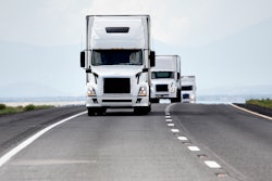Trio of white trucks on highway