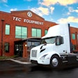 A Volvo electric truck parked in front of TEC Equipment.