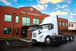 A Volvo electric truck parked in front of TEC Equipment.