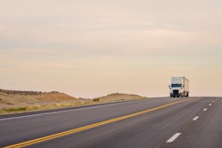 White truck going down long hill