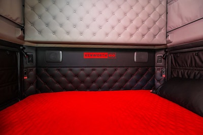 The interior of a sleeper cab with the bed pulled out.