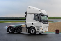 A white Hyzon Class 8 truck without a trailer on a race track.