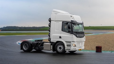 A white Hyzon Class 8 truck without a trailer on a race track.